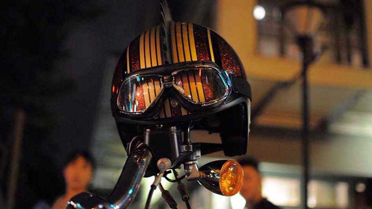 摩托车 头盔 and goggles placed on a motorcycle handlebar